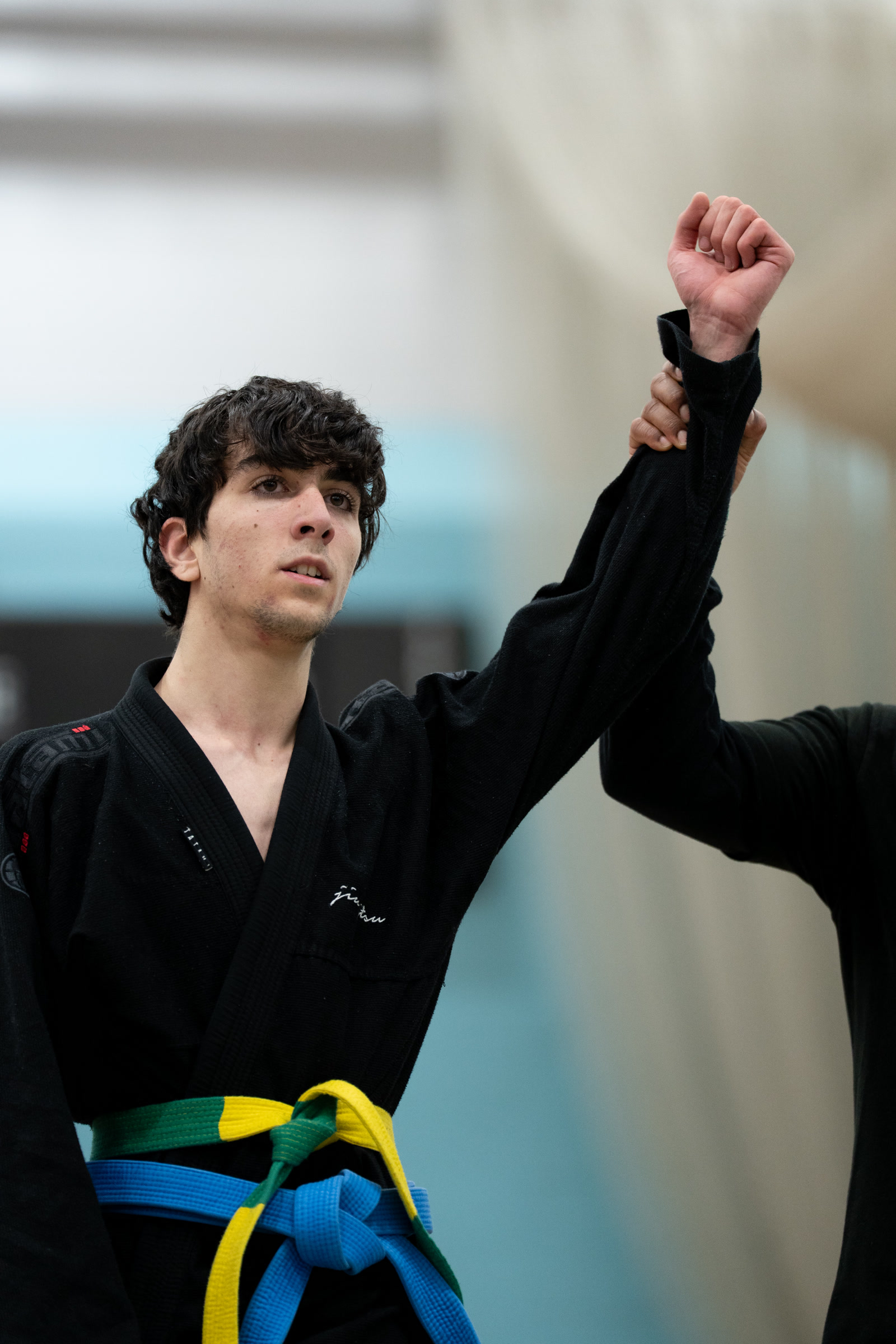 Junior student with hand raised in victory