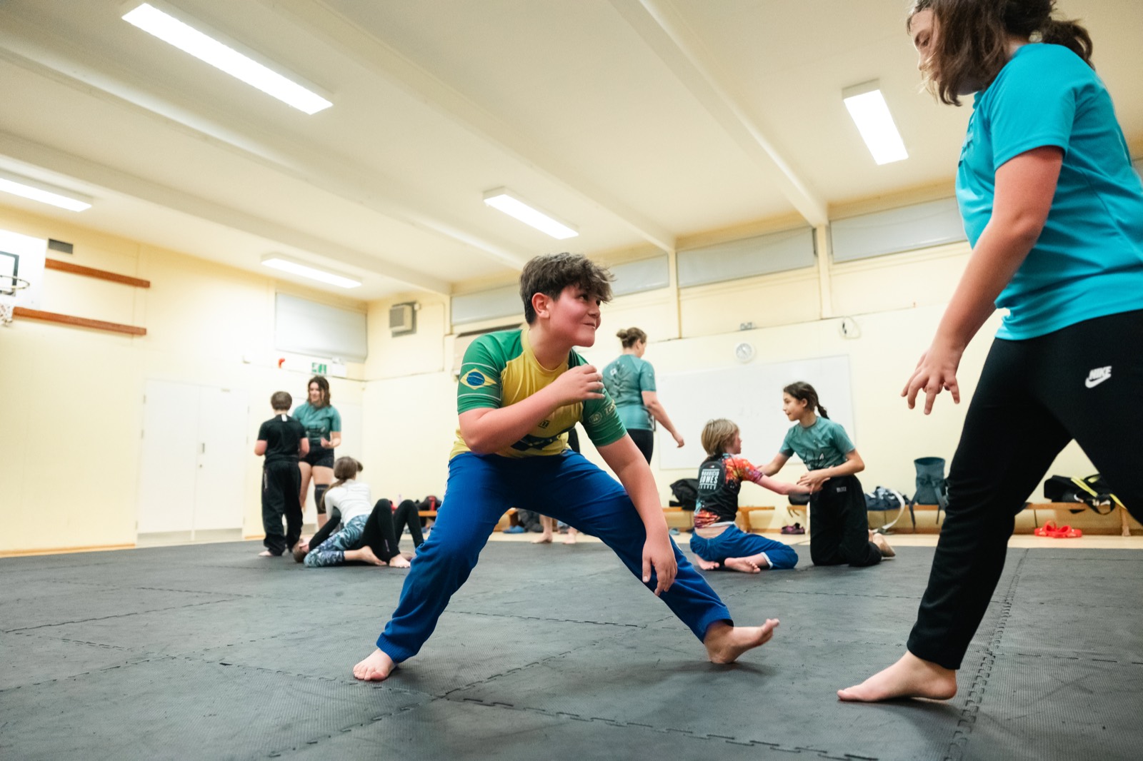 Children training Jiu Jitsu in a school hall
